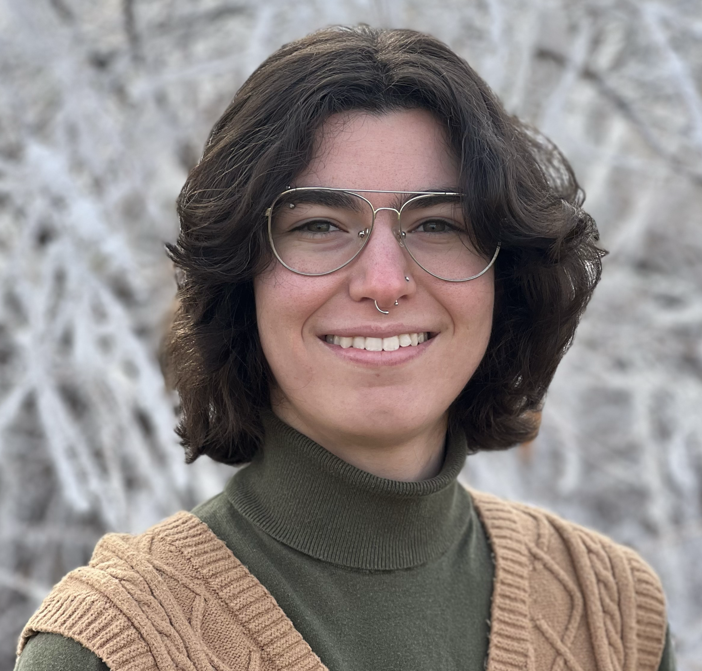 A headshot of Rebecca Novis from the shoulders up. She is smiling at the camera.